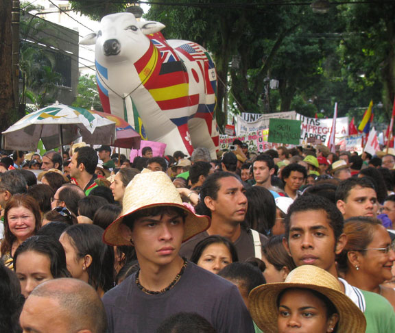 cow-under-mangueiras_6602 After a half hour the rains stopped and the march never did. Here's a big multinational cow under the ubiquitous mango trees that line the old streets of Belem.
