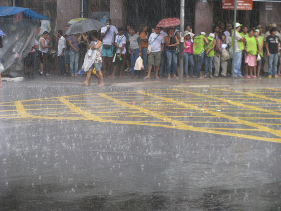 rain-in-street-and-sheltering-crowd_6525 When the rain started, most people took shelter, but plenty of diehards kept marching anyway.