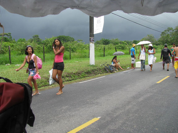 storm-from-bike-taxi_6919 Space opens in the pedestrian-crowded road while a dark storm approaches.