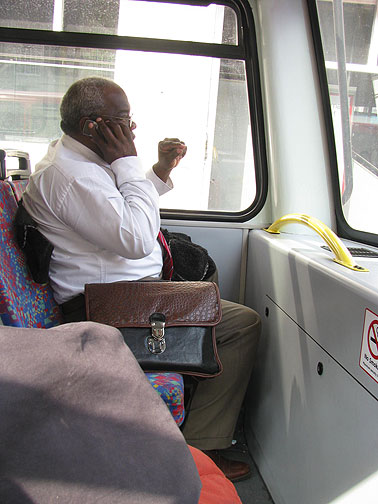 jamaican-businessman-on-bus_8399 This Jamaican businessman was across from me at the top of a doubledecker bus, running his office from the front seat, while I was rolling northward for my lunch appointment.