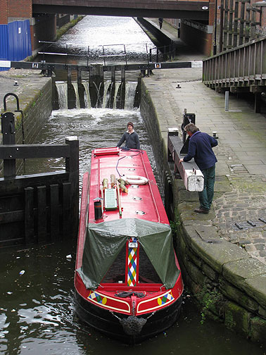 red-boat-passes-thru-lock_8519 Local canal boat makes its way through a lock.