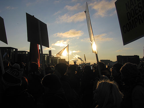 march-with-silhouette-from-Chritianhavn-bridge-and-power-plant_3872 December 12, 2009 march of 100,000 through Copenhagen demanding Climate Justice and "System Change, Not Climate Change!"