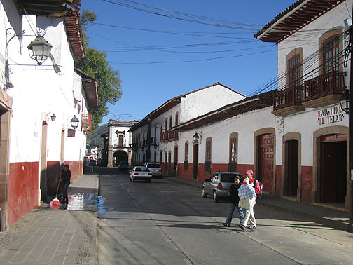 patzcuaro-street-scene_4290 This is the standard look of central Patzcuaro. The Plaza de Don Quiroga is at the end of the street in this photo, and you can see the signage over the door to the right.