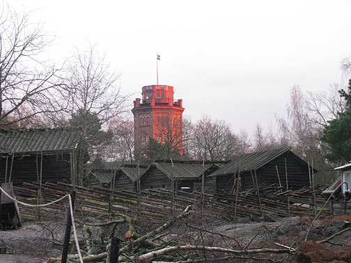 sunlit-tower-in-skansen-with-gray-buildings_3384 Setting sun on tower in Skansen, an open-air museum of historic Swedish buildings.