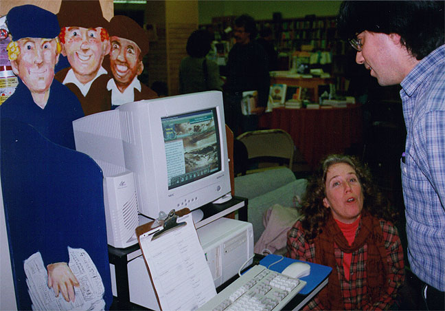 A better view of the first kiosk, art of the three "newsies" who grinned from behnd the computer by Mike Mosher.
