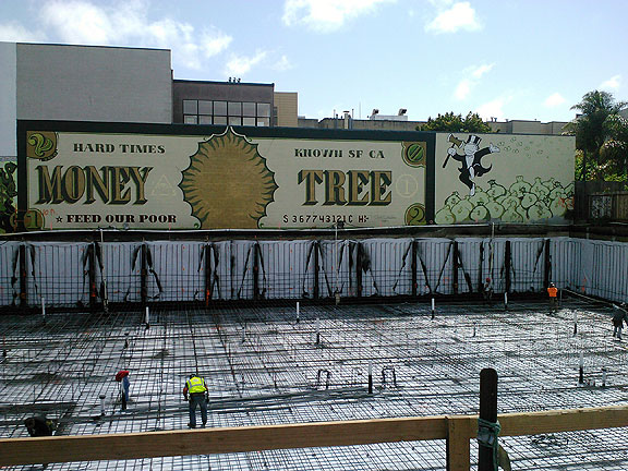 The foundation going in at 15th and South Van Ness for a 5-story condo project... note the funny mural that is being covered up by the construction...