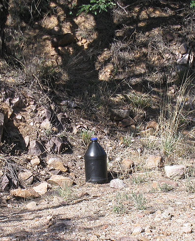 Migrants generally carry water bottles painted black so they won't be seen by spotlights during night crossings.