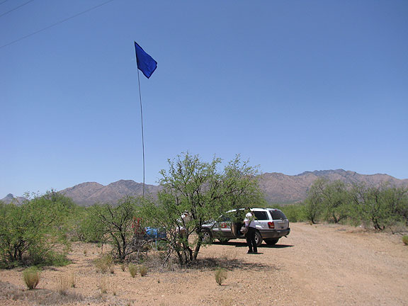 Blue water tank in desert, one of several efforts to provide humanitarian relief to the thousands risking the boiling desert crossing.