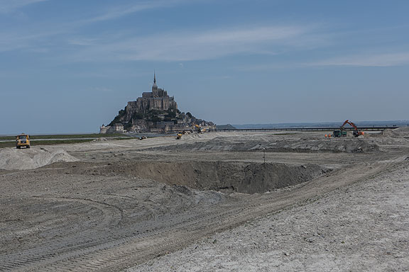 Approaching Mt. St. Michel now is to pass through an epic reorganization of the local tidelands to accommodate the endless flow of tourists.