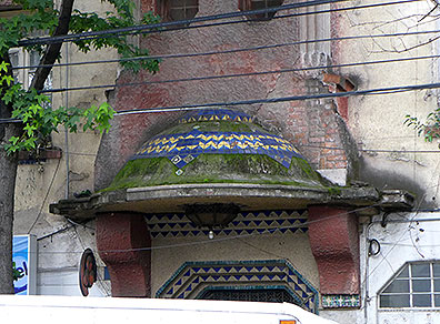 This tiled roof over a doorway on a decaying apartment building in Santa Maria de Ribera was easy to miss until I took a closer look.