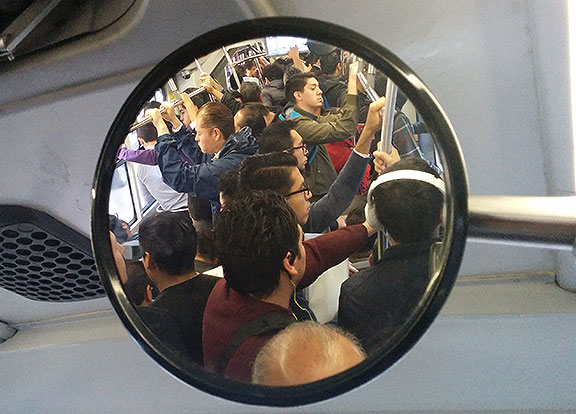 I took this photo inside a morning commute on the Metrobus, shooting into the mirror that looked up towards the front of the articulated vehicle.